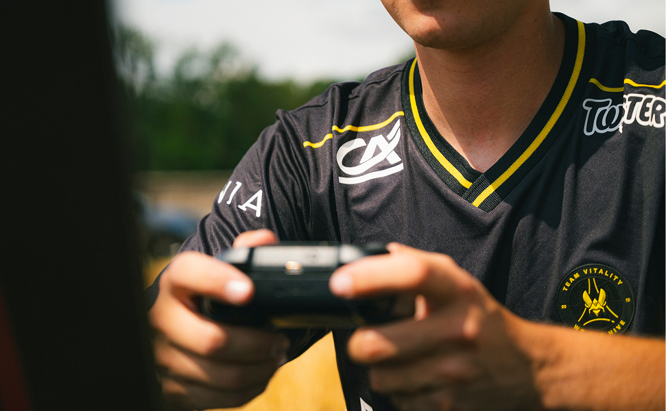 Portrait d'un joueur de Team Vitality en pleine partie de gaming dans un champ
